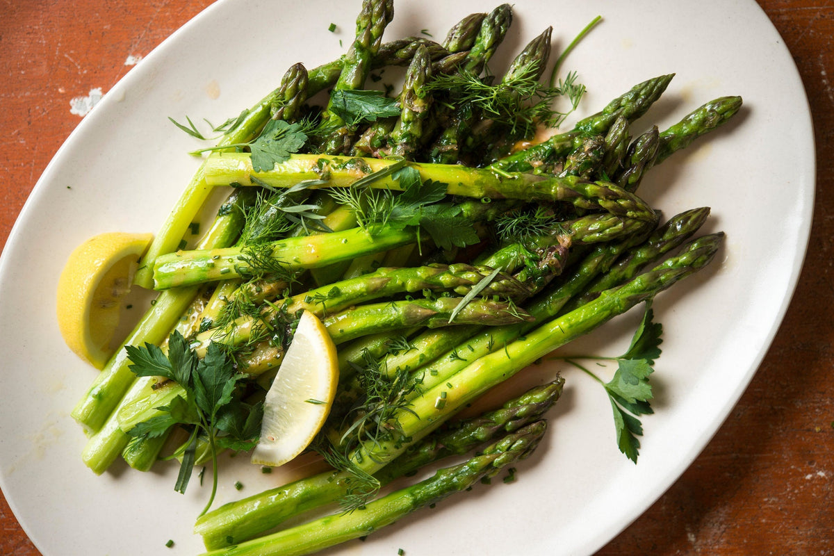Cooking fresh asparagus in a pan