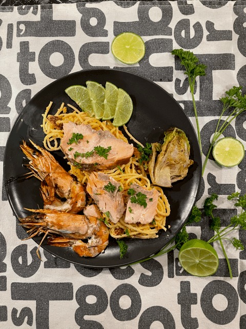 Spaghetti carbonara with fresh salmon, tiger prawns and little gem