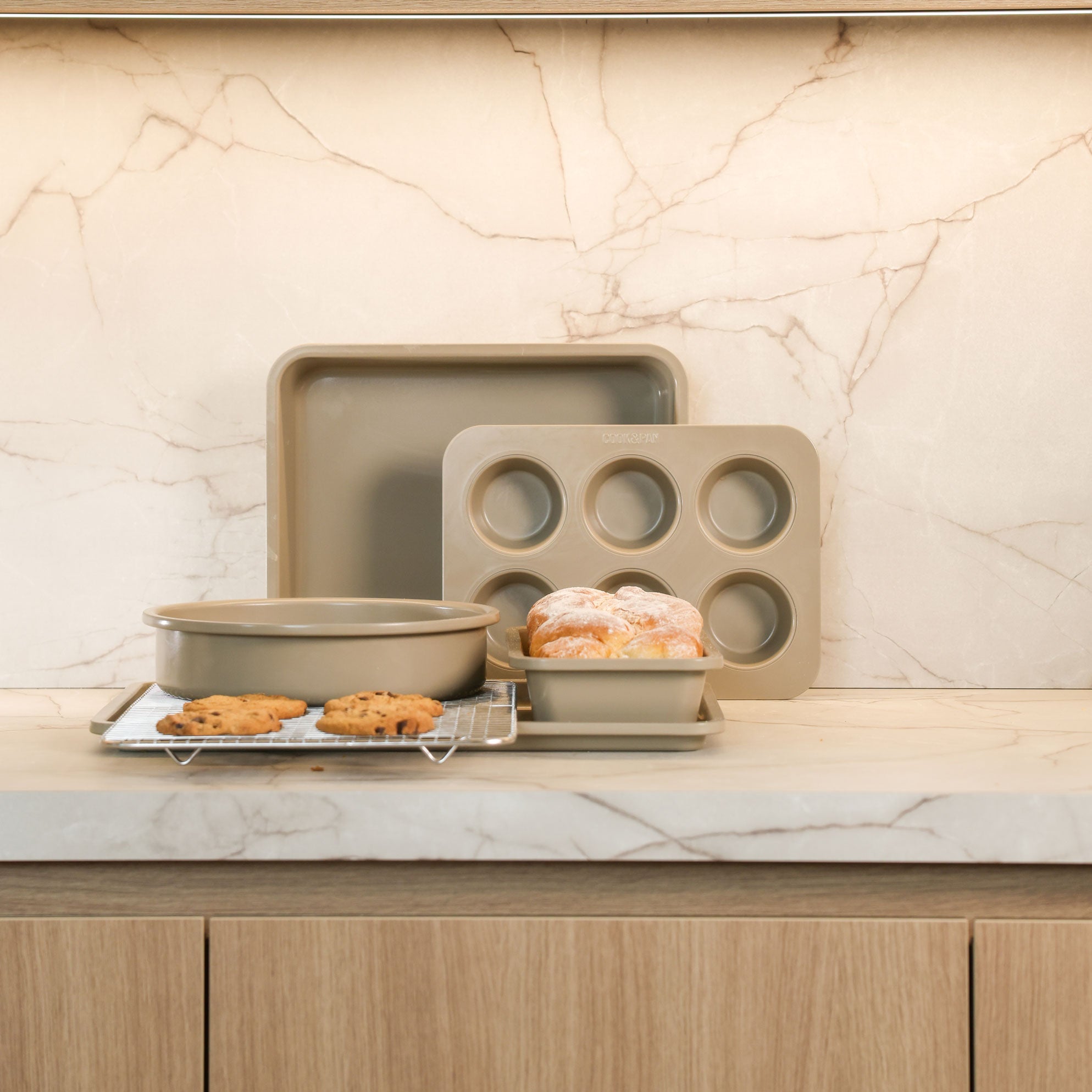 Taupe of Mind 10-piece baking set with pan, muffin tin and accessories on marble countertop with baked goods