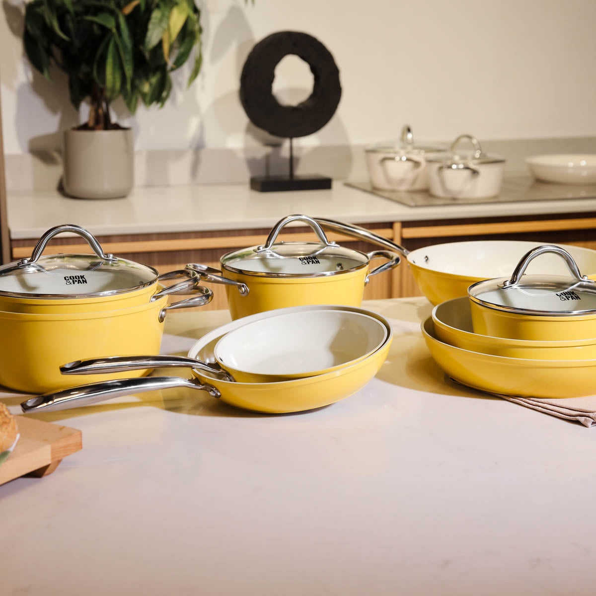 Yellow 9-piece cookware set with glass lids and stainless steel handles.