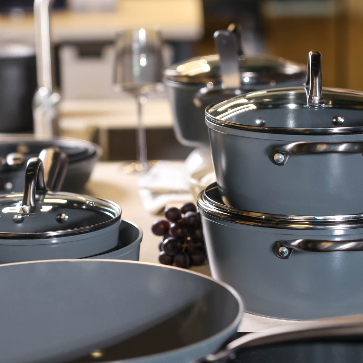 Gray 9-piece cookware set with glass lids and stainless steel handles.