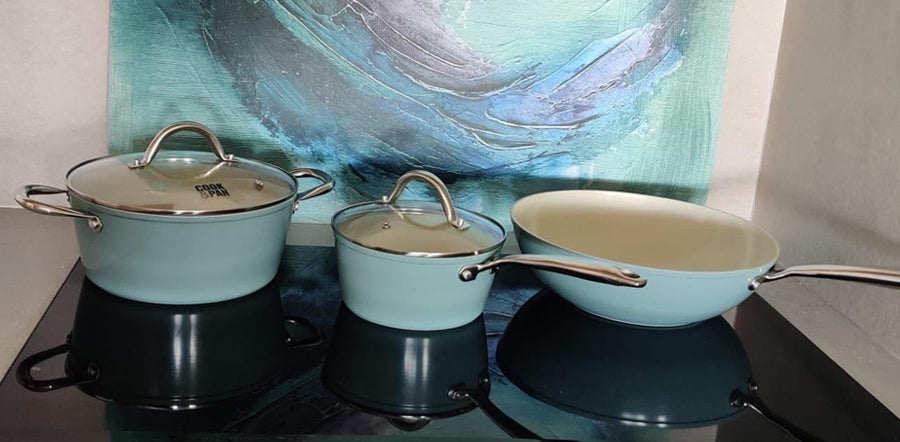 Set of blue 30 cm wok pan with lid, medium pan with lid, and light blue casserole pot with long handle.