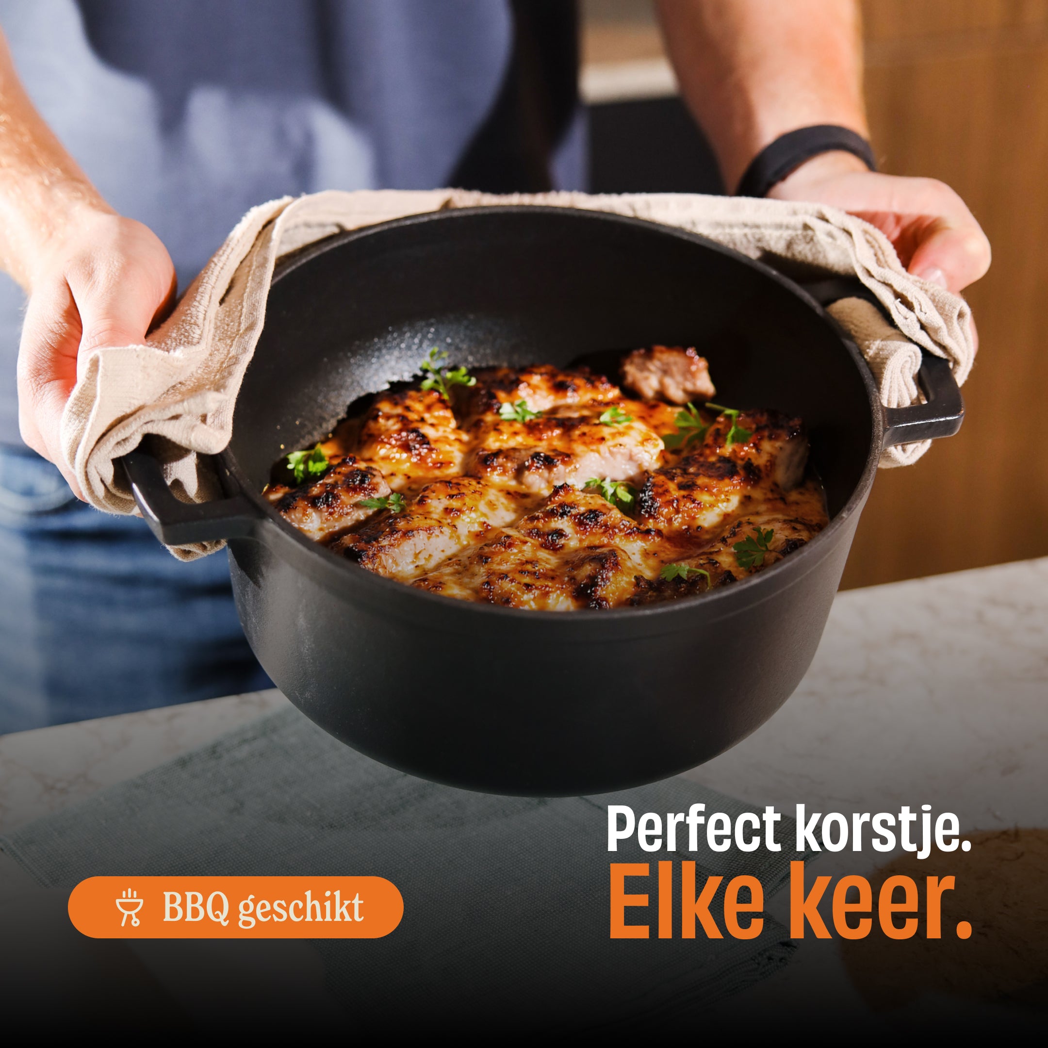Signature dutch oven with golden brown grilled chicken breasts garnished with greens, held above white marble.