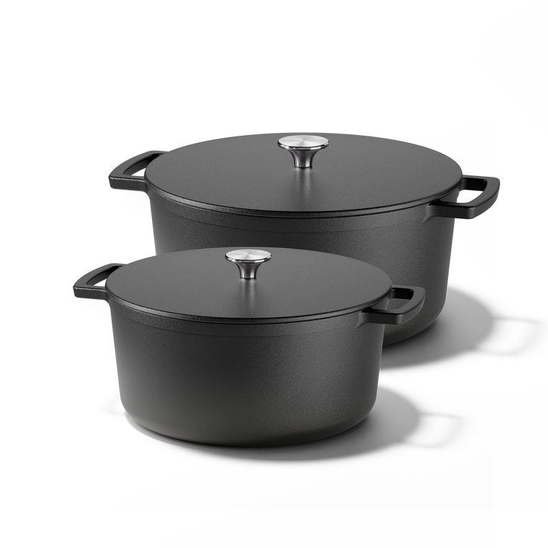 Signature cast iron Dutch oven set with two black cooking pots and lids featuring stainless steel knobs