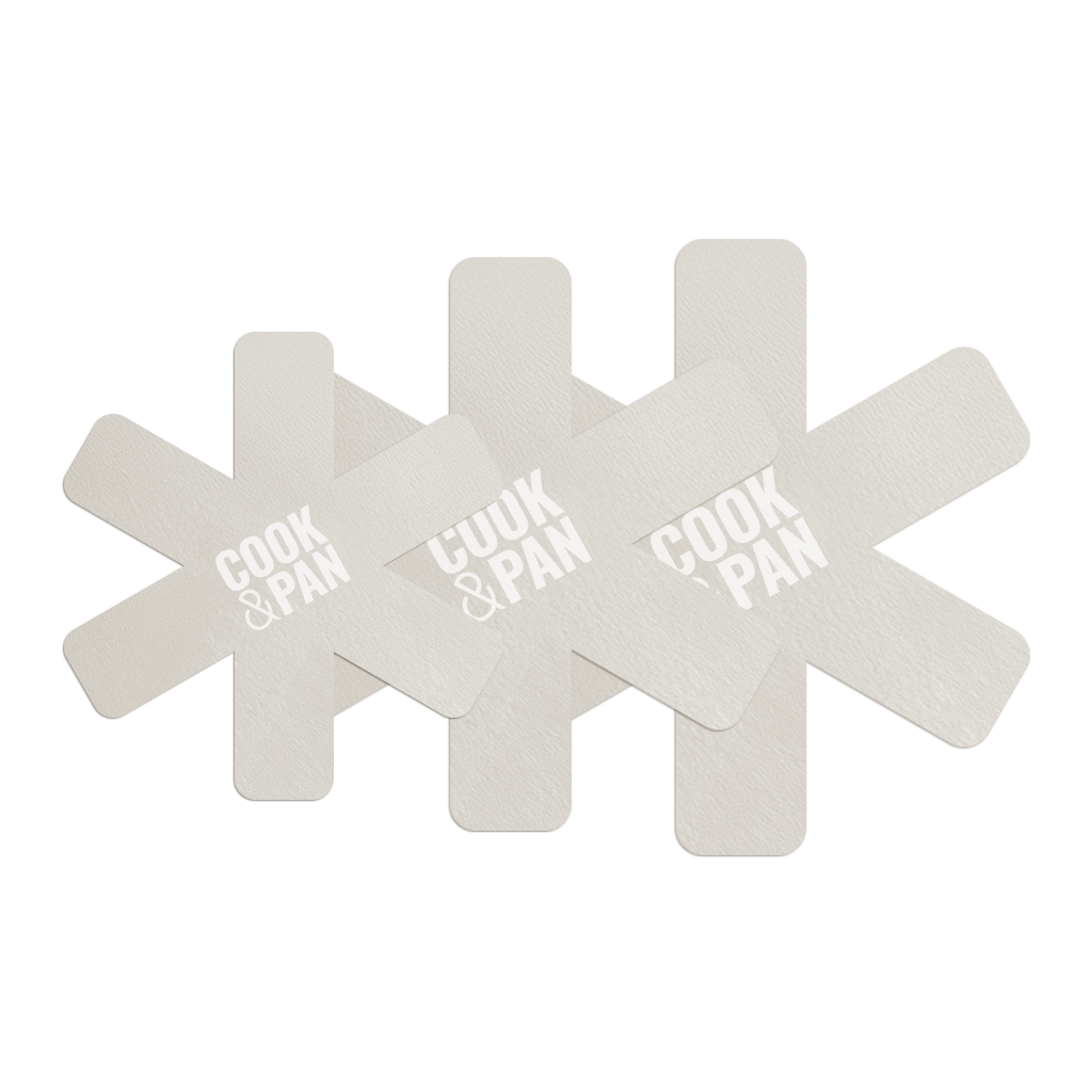 Three ivory-colored pan protectors with five protrusions and white print.