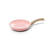 Pink frying pan 24 cm with non-stick coating and light wooden handle.