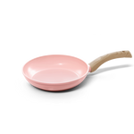 Pink frying pan with non-stick coating and light wooden handle, 28 cm diameter.