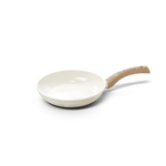 White ceramic frying pan with 20 cm diameter and light wooden handle.