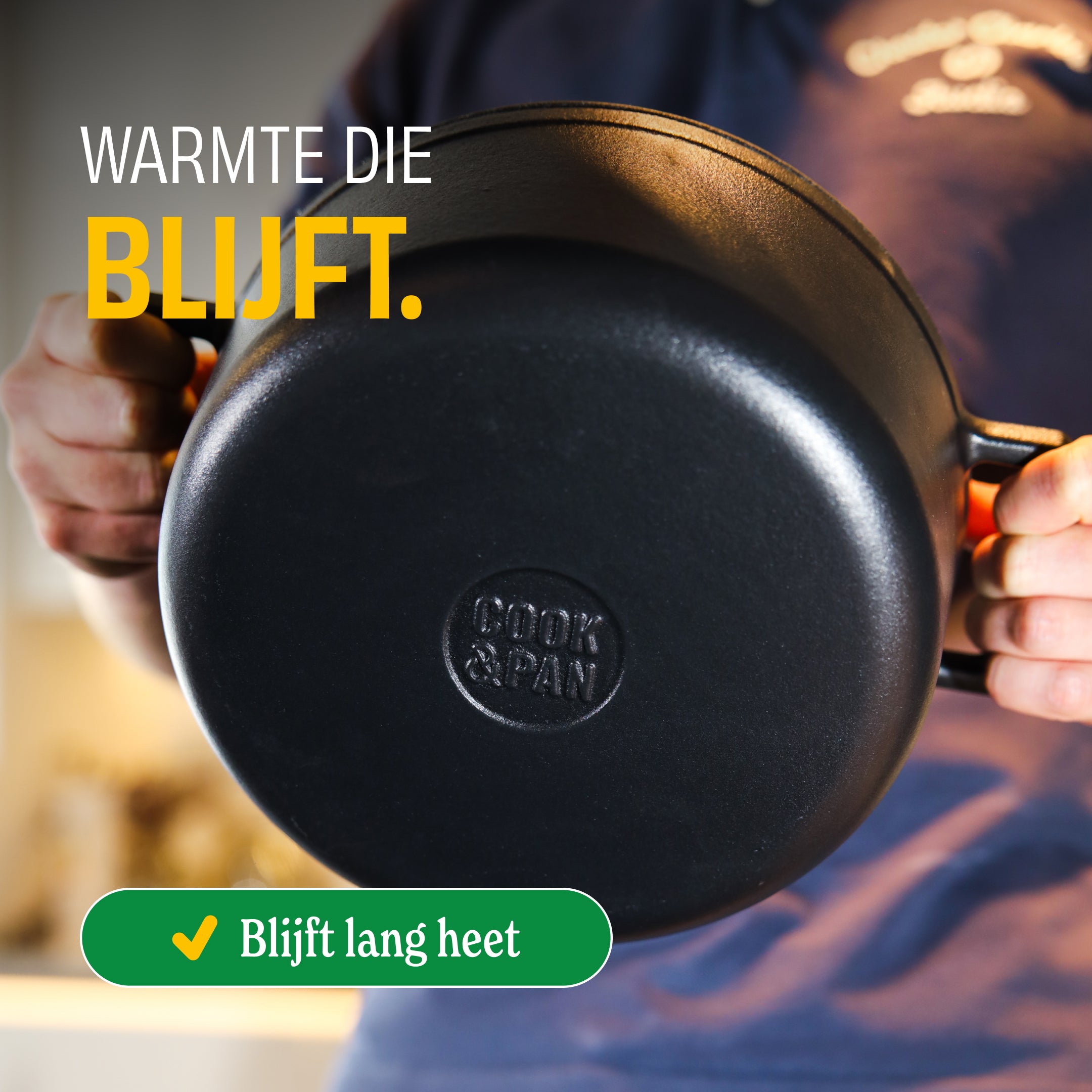 Hands holding a black cast iron Signature casserole pot that stays hot for a long time